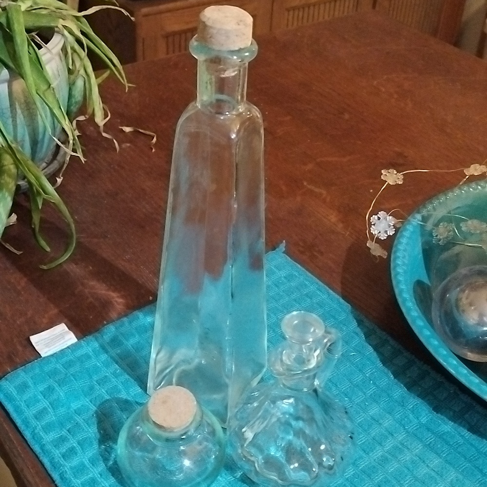 3 glass bottles with stoppers or corks